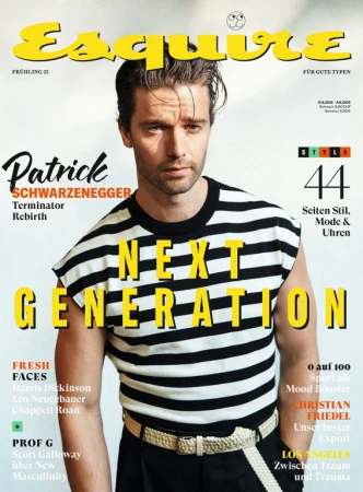 Magazine cover featuring a male model wearing a striped shirt and belt. The cover includes bold text and various article titles.