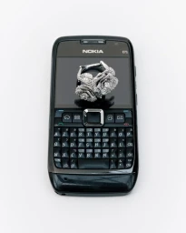 Diamond rose ring resting on the screen of a black mobile phone against a seamless white background.