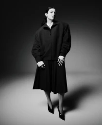 Lorde in a dark oversized jacket and skirt against a grey background for M Le magazine du Monde editorial project