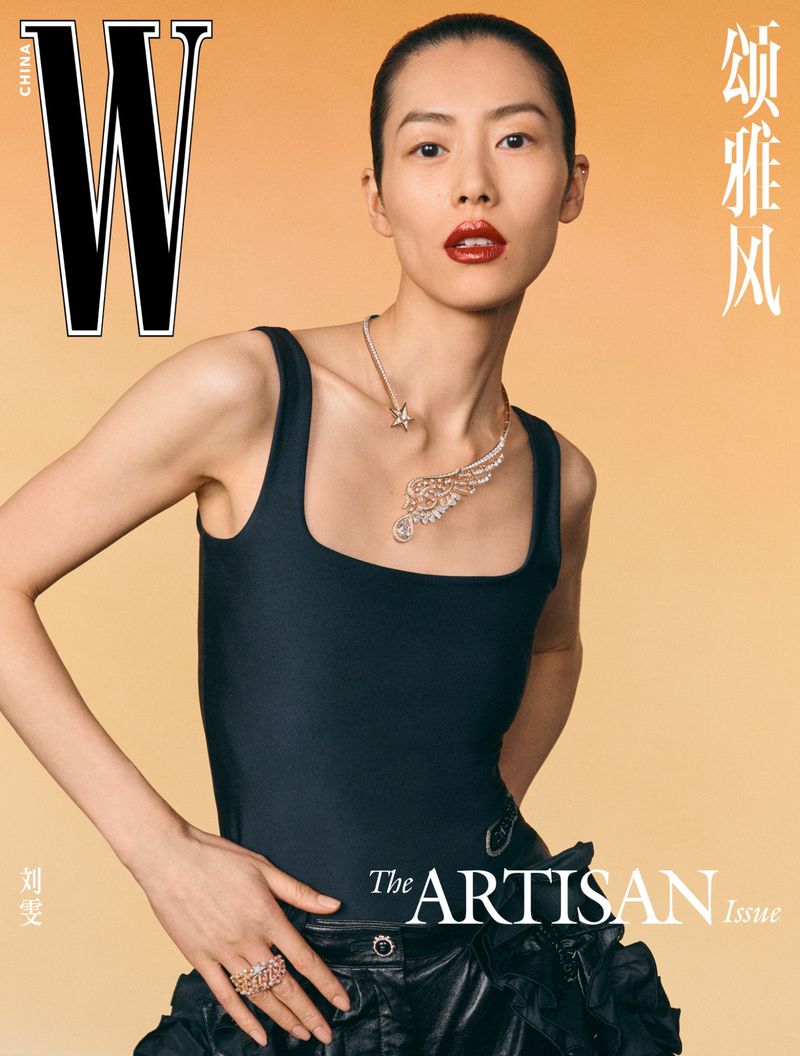 Magazine cover featuring a woman with dark hair and red lips wearing a black bodysuit and jewelry, against a peach-colored background.