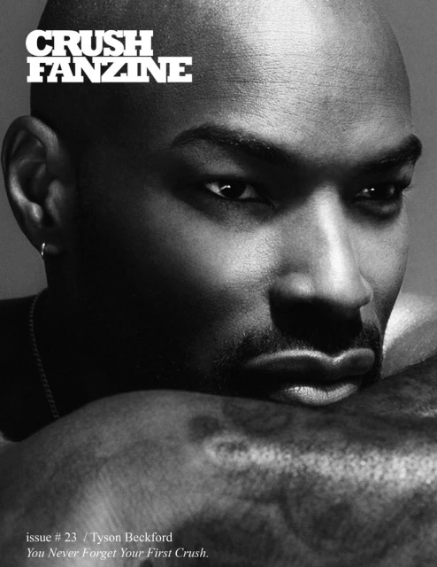 Monochrome close-up portrait of a Black male model, Tyson Beckford, gazing into the camera. Soft lighting highlights facial features. Magazine cover.