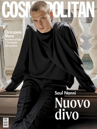 Actor Saul Nanni in a draped black long-sleeve top seated against a stone balustrade for the Cosmopolitan Italy Autumn 2025 cover.