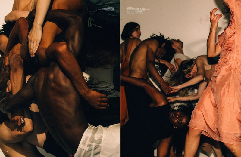 Fashion editorial shot of a group of diverse people intertwined in a pile, shot in a photo studio against a white background.