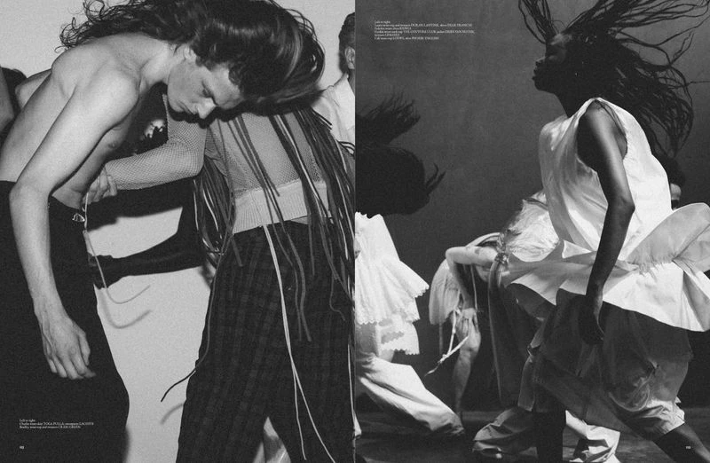 Editorial fashion shot with a group of diverse models in motion, wearing flowing clothing in a dynamic, high-contrast black and white composition.