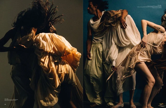 Group of dancers in flowing cream and white garments moving dynamically in a studio setting for a Dazed MENA fashion editorial.