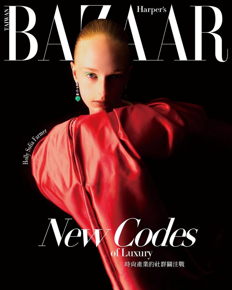 Harper's Bazaar magazine cover featuring a model in a red dress against a black background with the magazine's logo at the top.