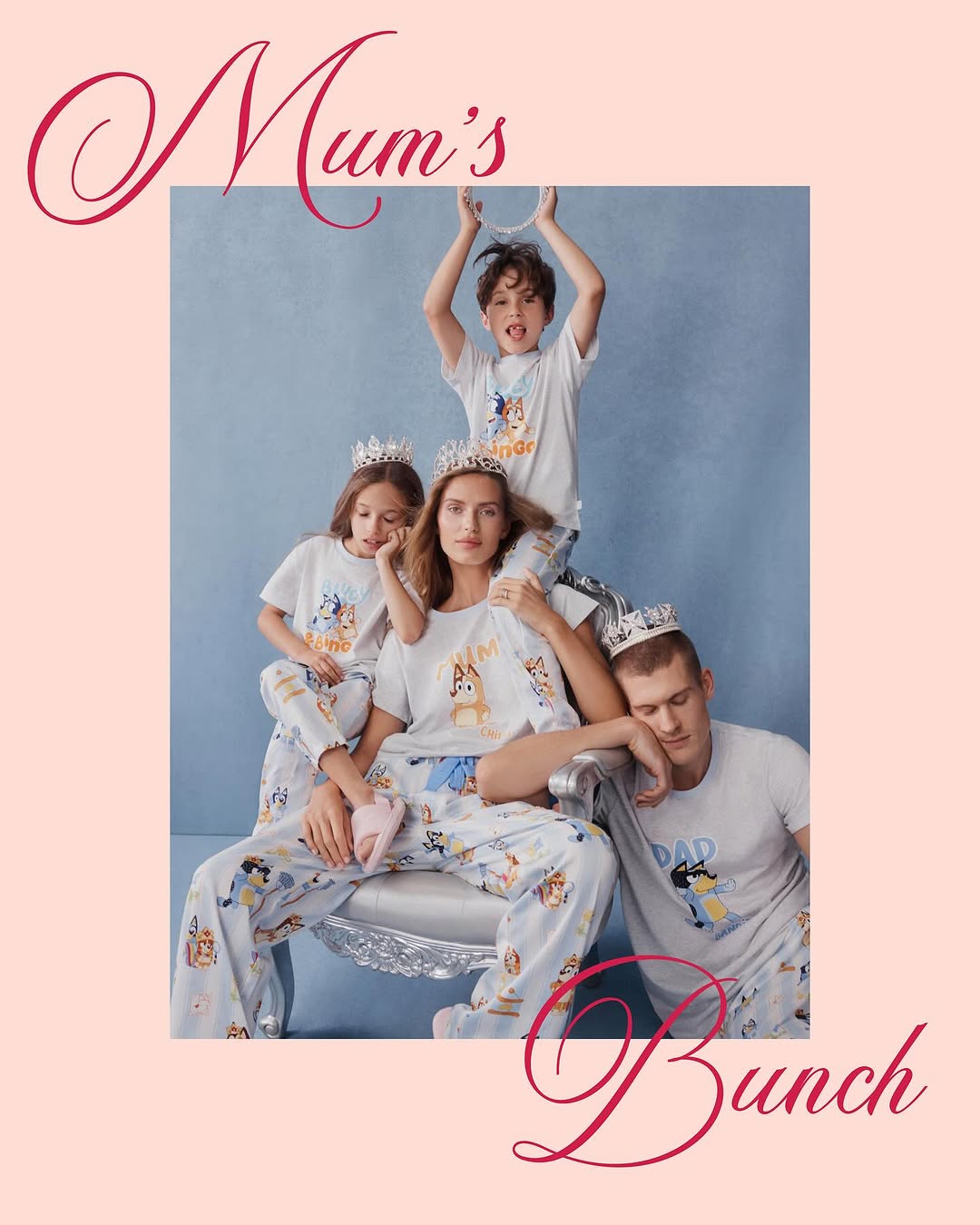 Family of five in matching Bluey pyjamas and silver crowns posing in front of a blue backdrop with light pink surrounding the image.