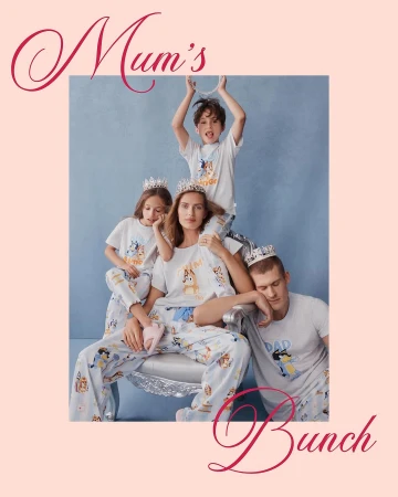 Family of five in matching Bluey pyjamas and silver crowns posing in front of a blue backdrop with light pink surrounding the image.