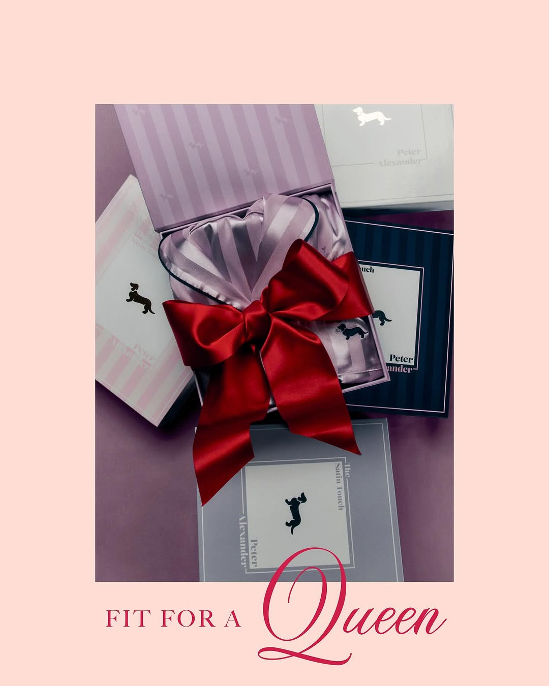 Gifts in striped boxes, one open with silk fabric and a large red bow. Product photography for beauty, cosmetics, or the holidays.