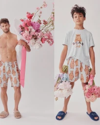 Man and boy holding large flower bouquets against a white background for Peter Alexander Thanks a Bunch campaign.