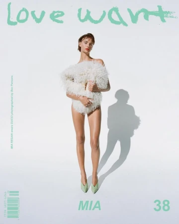 Model Mia Regan posing in a textured white garment and mint green pointed heels against a white studio background for Love Want Magazine.