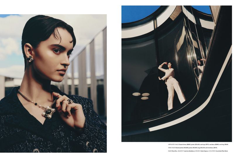 Fashion editorial shot with a young adult posing in a Chanel outfit and jewelry with an architectural background, promoting beauty and style.