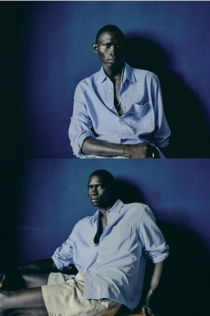 A dark-skinned man in a light blue button-down shirt poses in a diptych, one half in the torso and one half seated against a blue background.