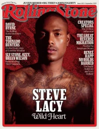 Portrait of Steve Lacy on the September 2025 cover of Rolling Stone magazine with tattoos visible on his chest and arms.