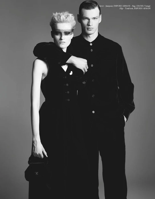 Sterre Haket wearing a lace eye mask alongside Filip Hrivnak in black outfits against a neutral studio backdrop for Double Jeu.
