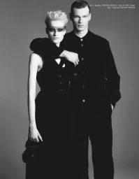 Sterre Haket wearing a lace eye mask alongside Filip Hrivnak in black outfits against a neutral studio backdrop for Double Jeu.
