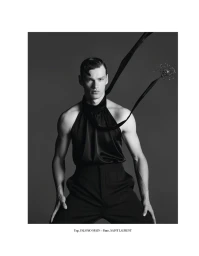Model Filip Hrivnak in a black halter top and tailored trousers with floating neck ribbons in a monochrome studio portrait.
