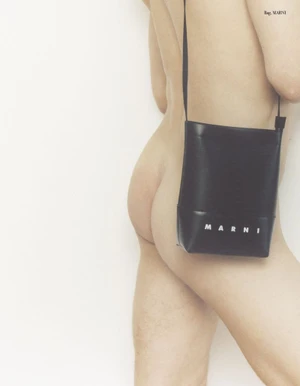 Model shown in profile wearing a black shoulder bag against a plain white background for Archives Futures.