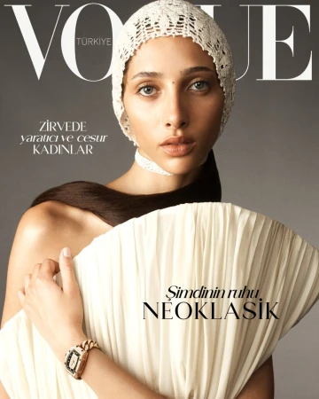 Vogue Turkey magazine cover featuring a model in a white crocheted bonnet and dress, with bold text and a gray background.