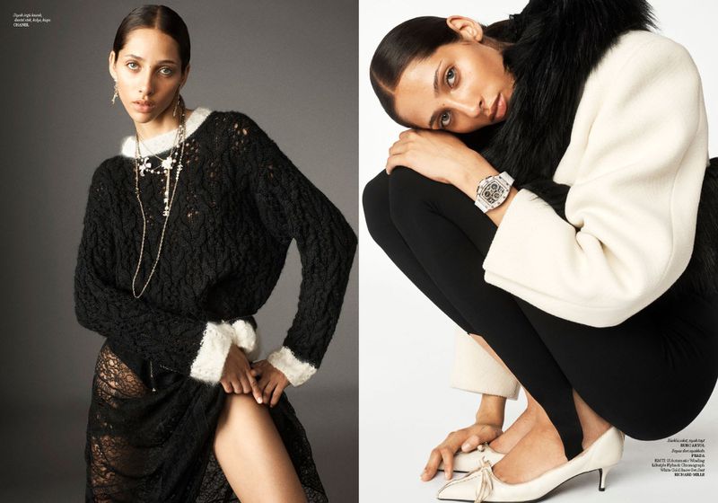 Fashion editorial shot of a mixed-race woman wearing a black knitted sweater and a lace skirt, plus a model wearing a coat with black leggings.