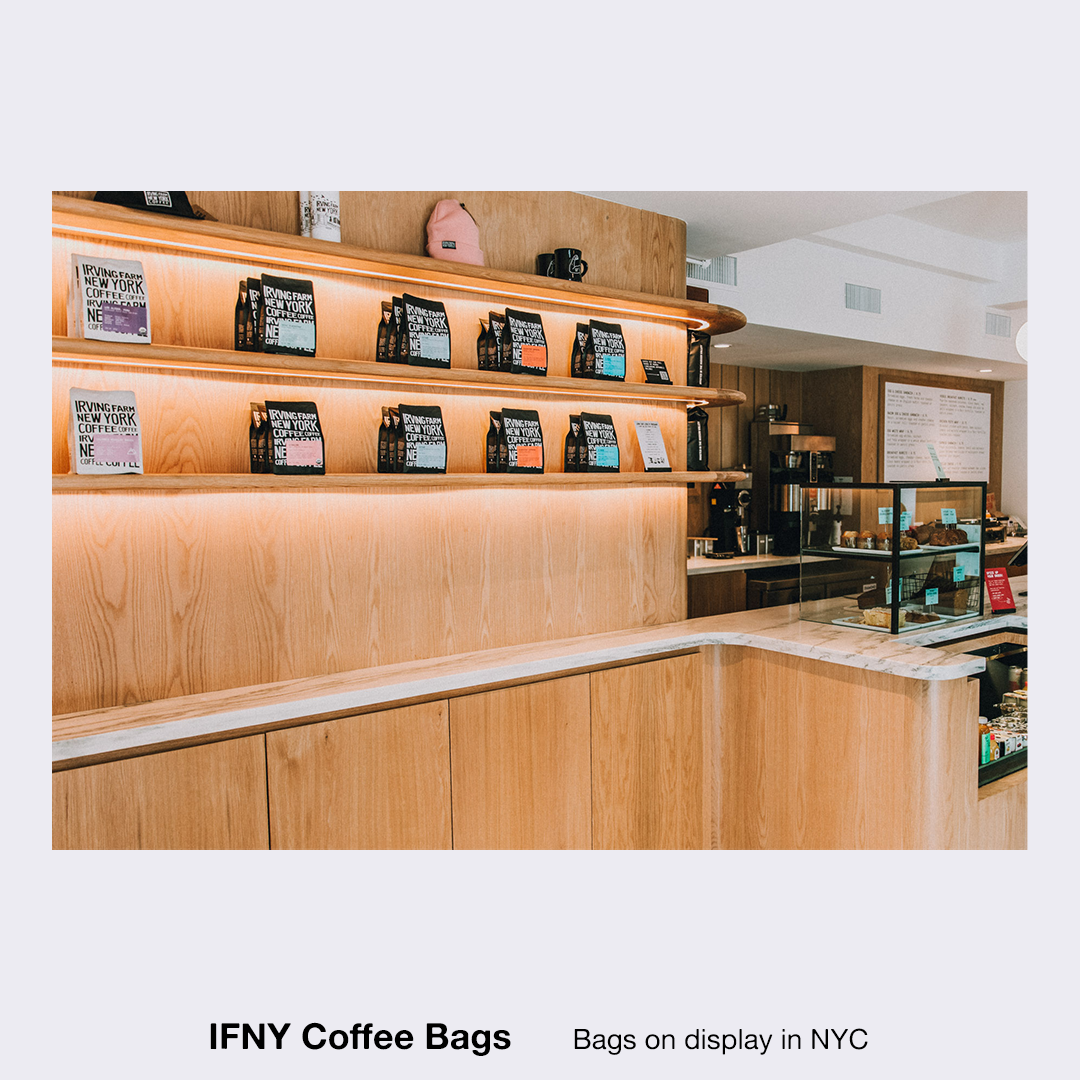 Brightly lit coffee shop display with packaged coffee beans and brewing equipment, showcasing a modern aesthetic and inviting atmosphere.
