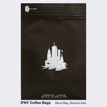 Black coffee bag features a white New York City skyline graphic, including the World Trade Center, coffee cup, and eye illustration.