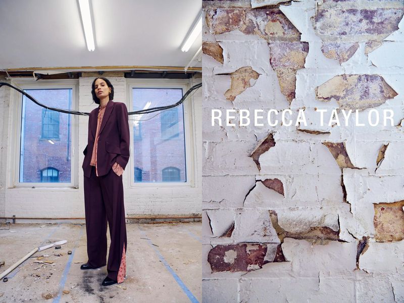 Woman in a burgundy suit in a derelict interior next to a painted brick wall with Rebecca Taylor text. Fashion editorial shot.