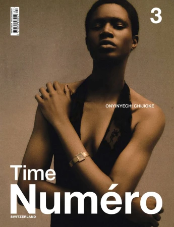 Magazine cover featuring an African woman with a gold wristwatch in medium shot, wearing a sleeveless top against a neutral background.