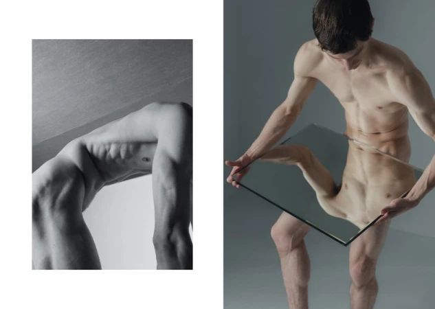 Two nude men in a studio. One man is bent over backwards and the other man is holding up a mirror, with reflected body parts.