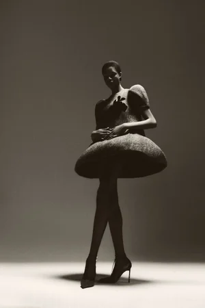 Onyinyechi Chijioke in a sculptural bubble dress and stilettos against a studio backdrop for Numéro Switzerland.