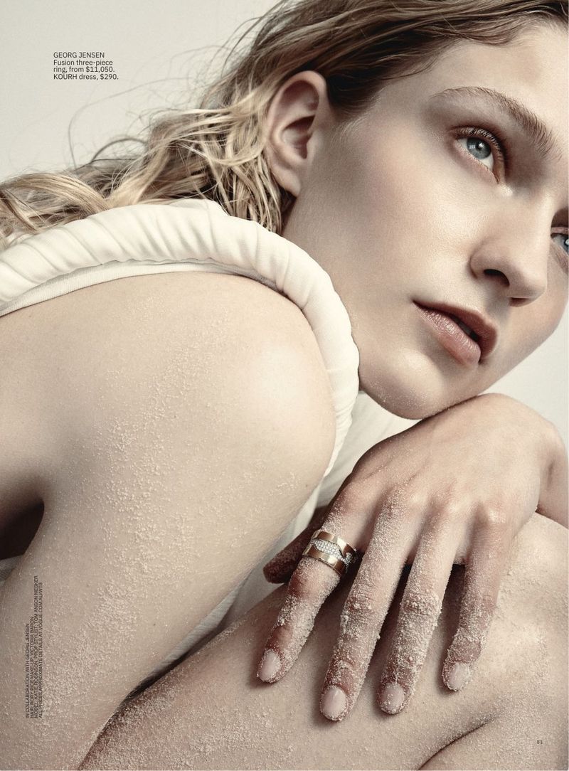 Blonde woman poses in studio wearing Georg Jensen jewelry and Kolby dress, sandy textures. Beauty and fashion editorial photography.