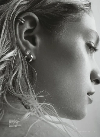 Close up profile portrait of a model wearing a gold ear cuff and hoop earrings for Vogue Australia