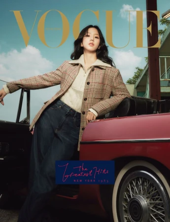 Magazine cover featuring a woman in a houndstooth jacket and jeans posing next to a red convertible against a sky-blue background.