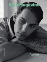 Monochrome close-up portrait of Francesco Di Napoli resting his chin on crossed arms with a visible forearm tattoo.