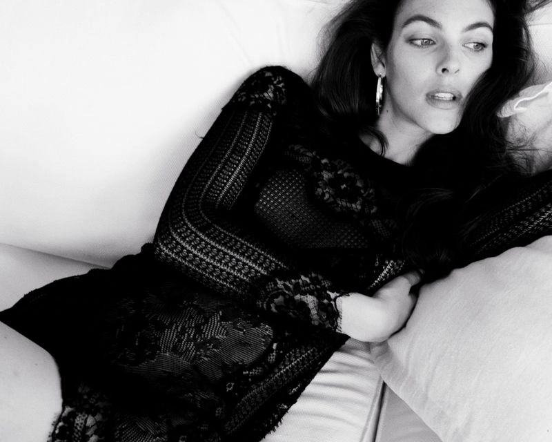 Vittoria Ceretti reclining on a white sofa wearing a black lace dress for D Repubblica photographed by Oliver Hadlee Pearch.