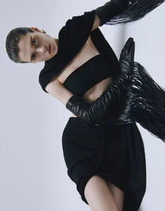 Model wearing a black bandeau top, black skirt, and long leather gloves against a white background for L'Officiel Malaysia editorial
