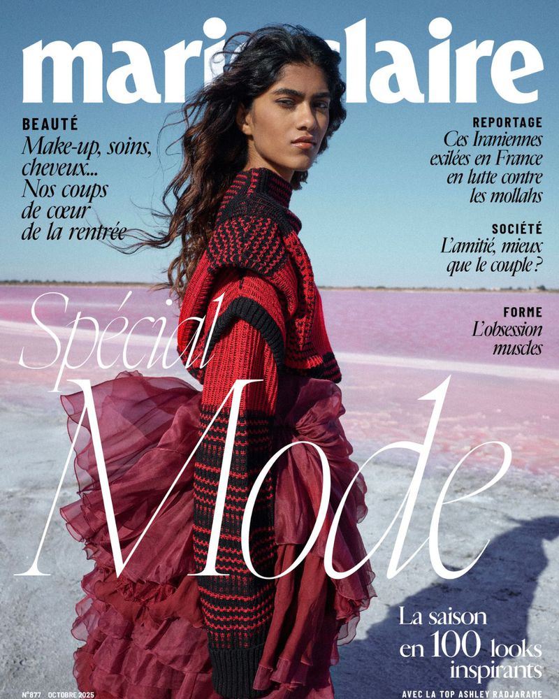 Marie Claire magazine cover featuring a South Asian female model in a red and black knit top and a red ruffled skirt against a pink lake.
