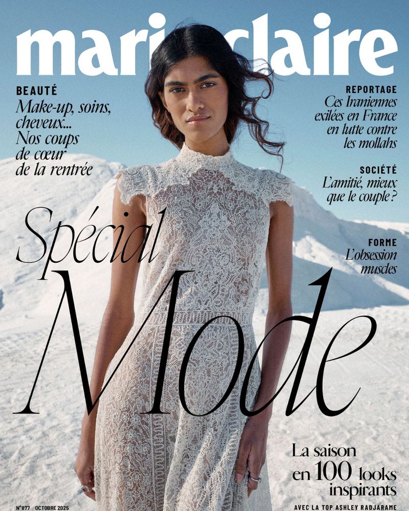 Magazine cover featuring a woman in a white lace dress against a background of white sand and a blue sky. "Marie Claire" logo at the top.
