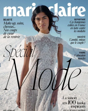 Magazine cover featuring a woman in a white lace dress against a background of white sand and a blue sky. "Marie Claire" logo at the top.