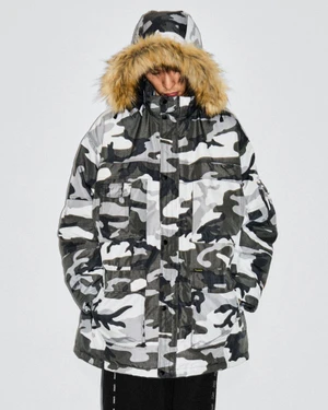 Model wearing a white and grey camouflage winter parka with a faux fur hood against a plain white background
