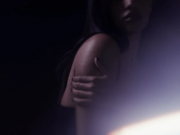 Cinematic low-key shot of a woman holding her bare arm with dark manicure in dim lighting and soft lens flare.