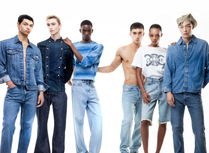 A group of six fashion models posing in denim clothing against a bright background, showcasing various denim styles.