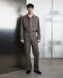 Model Yuto Ebihara wearing a taupe utilitarian collared jacket and matching trousers for the Helmut Lang Fall/Winter 2025 lookbook.