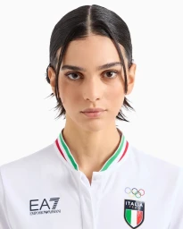 Meriam Turki wearing a white Emporio Armani EA7 Italia Olympics polo against a plain white background.
