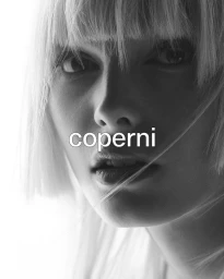 Close-up monochrome portrait of Alex Consani with blonde bangs for the Coperni F/W 2025 campaign shot by Karim Sadli.