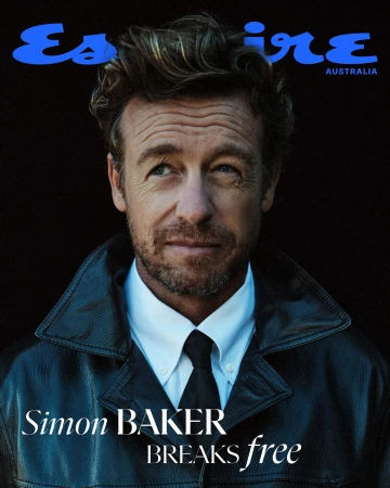 Close-up of Simon Baker on Esquire Australia cover, wearing a leather jacket, white shirt, and black tie, against a dark backdrop.