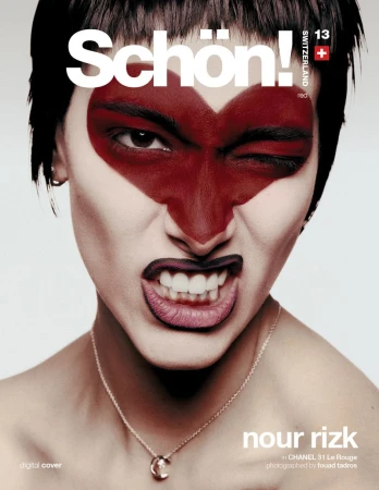 Magazine cover featuring a woman with dramatic red heart-shaped makeup, dark lipstick, and a striking facial expression.