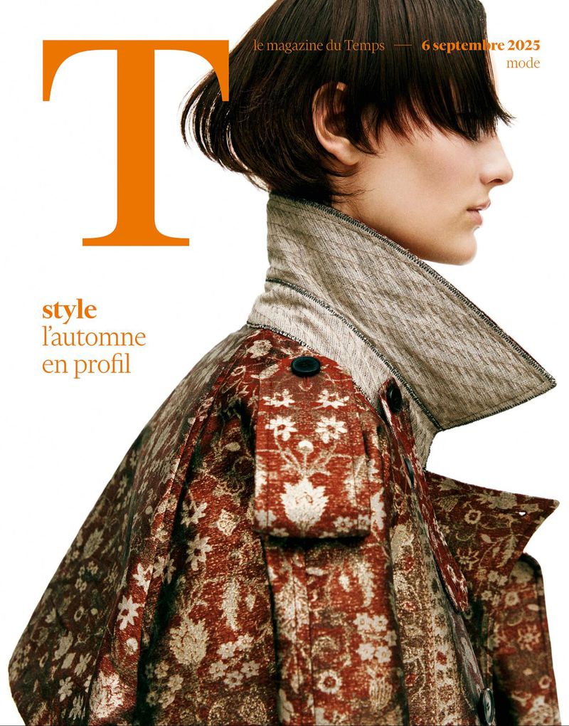 Fashion magazine cover featuring a female model in profile, wearing a patterned coat with a high collar and short dark hair.