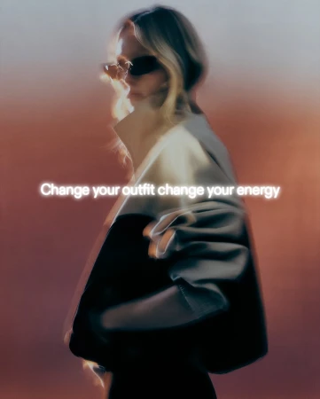 Blonde woman in sunglasses and a two-tone jacket poses in a blurred fashion shot with text overlay against a warm gradient backdrop.