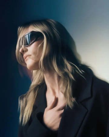 Model in dark sunglasses and black jacket against a moody background for Deering Collection 03